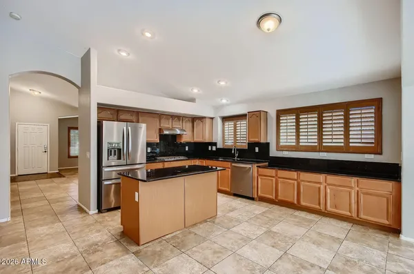a kitchen with stainless steel appliances granite countertop a stove and more cabinets