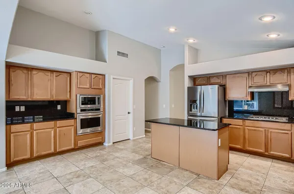 a kitchen with stainless steel appliances a stove sink and microwave
