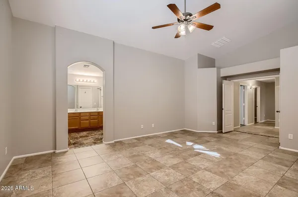 a view of an empty room and kitchen