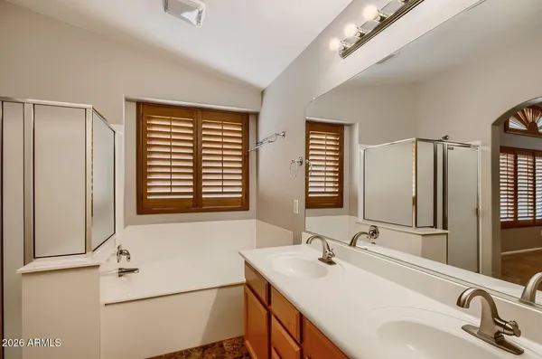 a bathroom with 2 sink and a mirror
