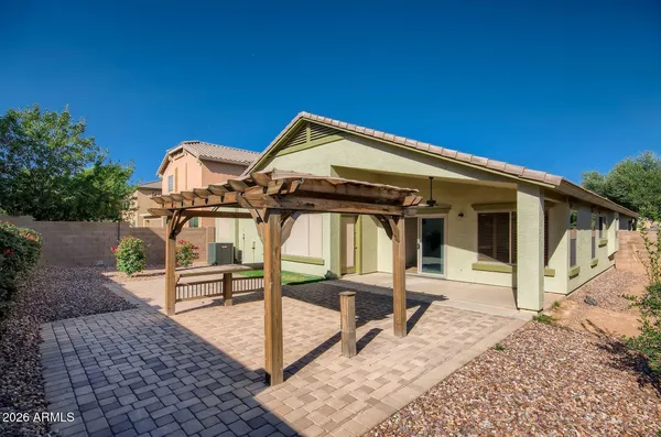 a front view of a house with wooden deck and furniture