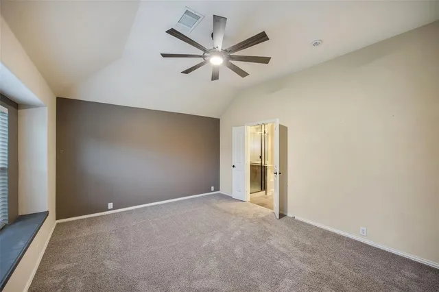 an empty room with closet and windows