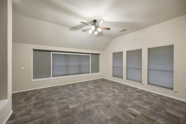 a view of an empty room with a ceiling fan