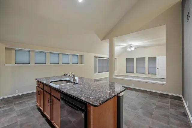 a kitchen with a sink a counter top space and cabinets