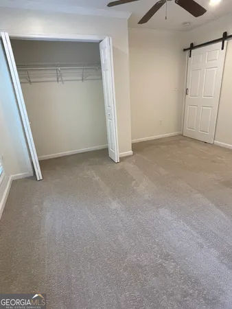 a bathroom with a granite countertop toilet and a sink
