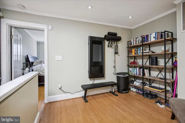 a living room with furniture and a book shelf