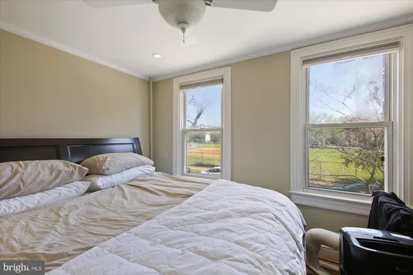 a bedroom with a bed and glass window