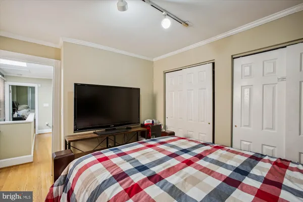 a bedroom with bed and a flat screen tv