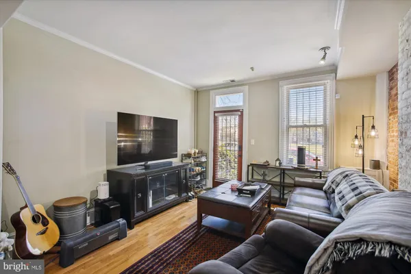 a living room with furniture and a flat screen tv