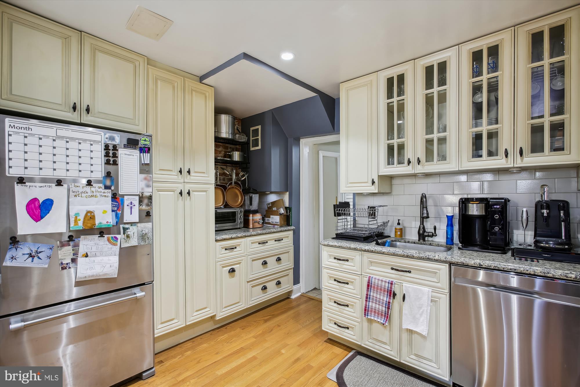 763 10th Street Southeast Washington, DC 20003 - Photo 8 of 20 a kitchen with stainless steel appliances kitchen island granite countertop a refrigerator and cabinets