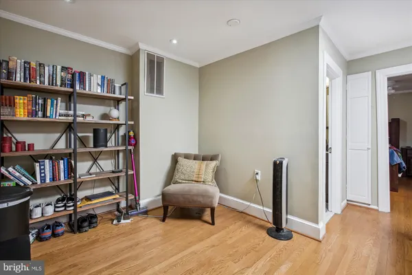 a living room with furniture and a book shelf