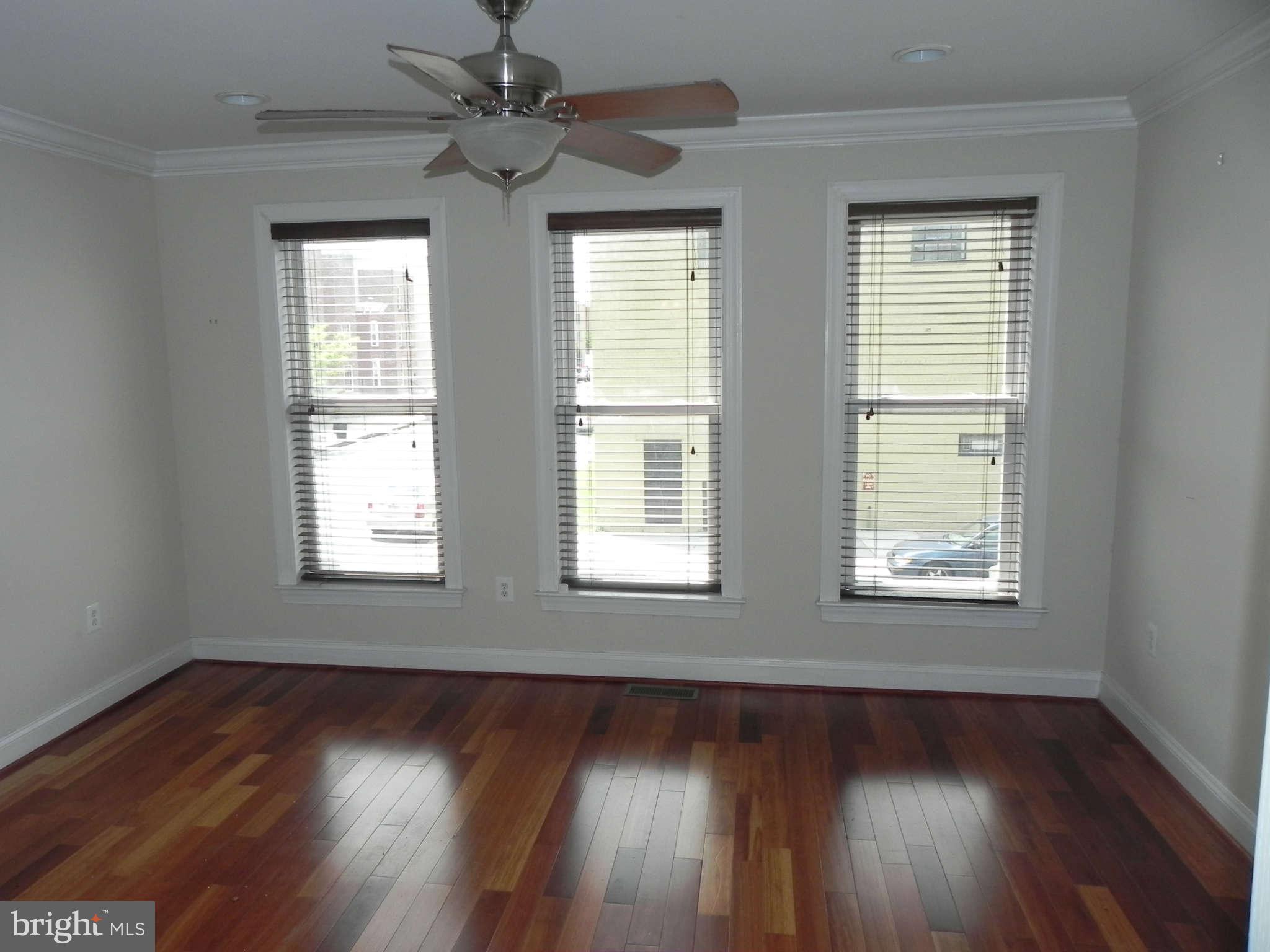 106 West Cross Street Baltimore, MD 21230 - Photo 11 of 29 a view of an empty room with wooden floor and a window