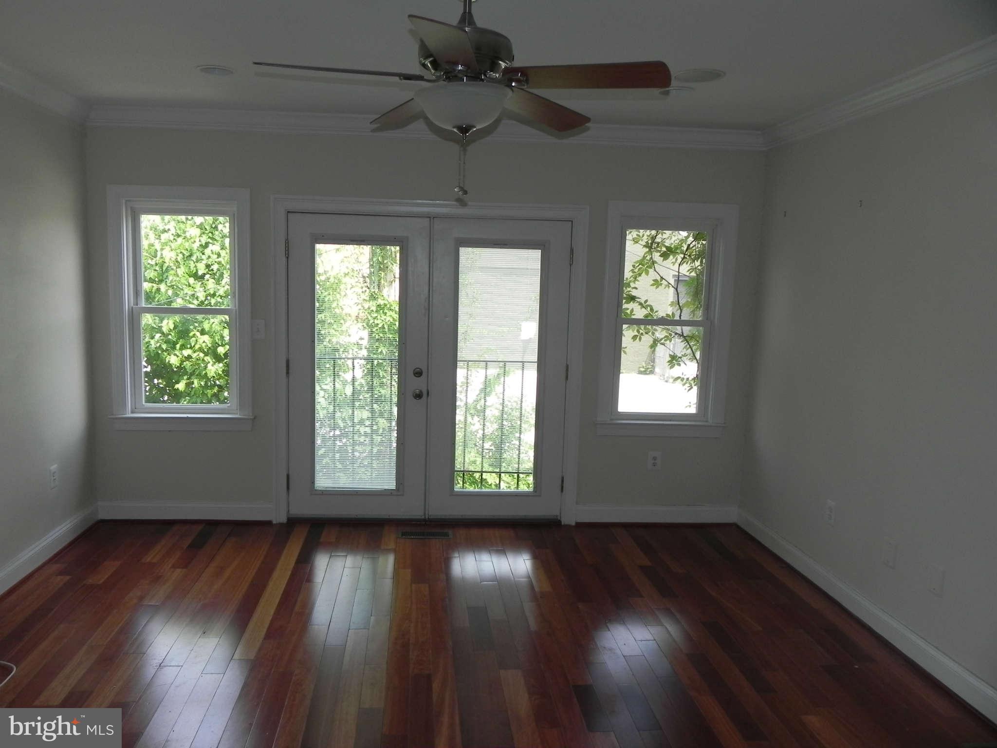 106 West Cross Street Baltimore, MD 21230 - Photo 12 of 29 a view of an empty room with wooden floor and a window