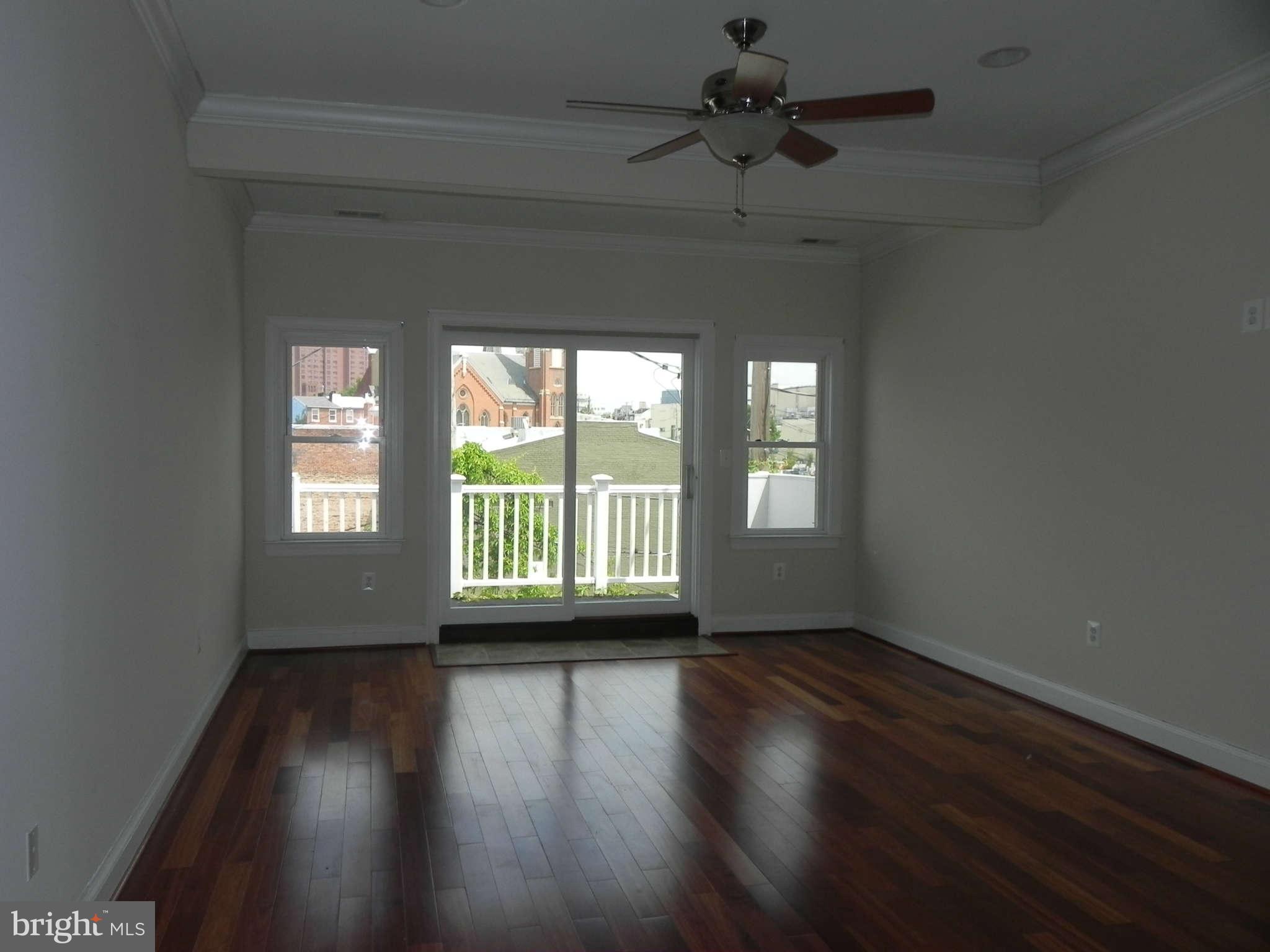 106 West Cross Street Baltimore, MD 21230 - Photo 17 of 29 a view of an empty room with wooden floor and a window