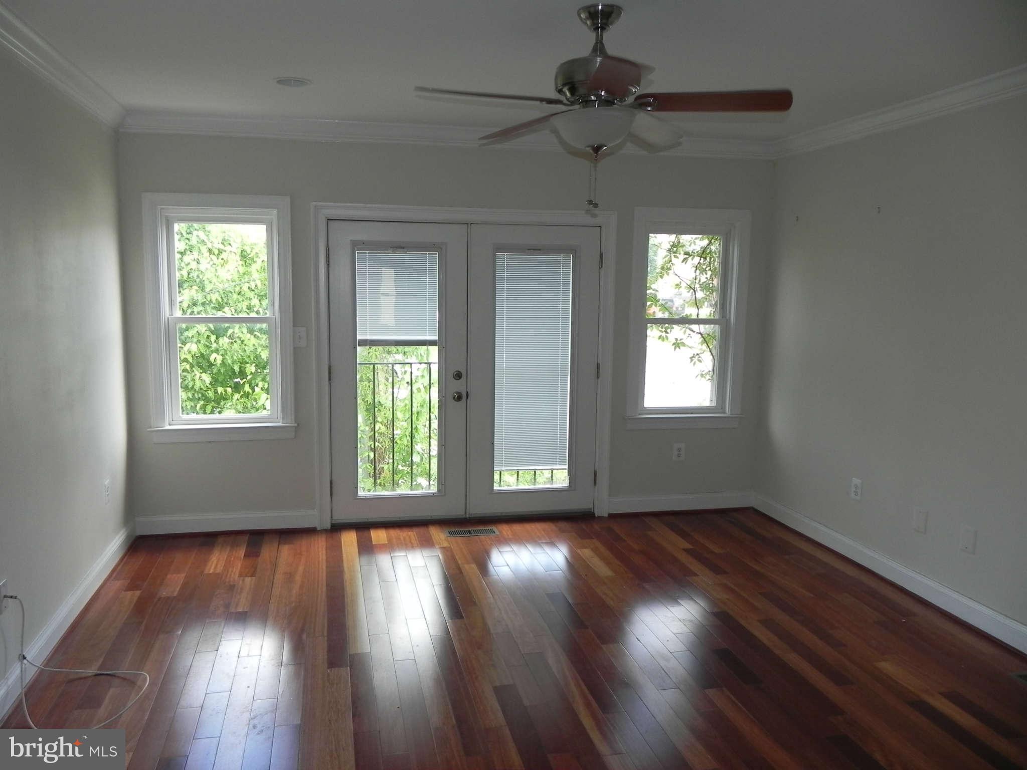 106 West Cross Street Baltimore, MD 21230 - Photo 18 of 29 a view of an empty room with wooden floor and a window