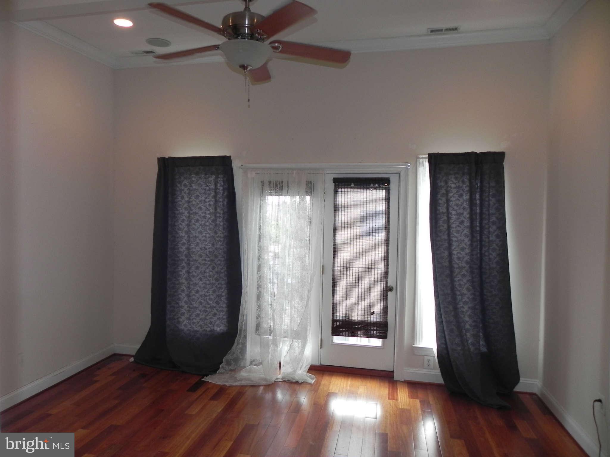 106 West Cross Street Baltimore, MD 21230 - Photo 23 of 29 wooden floor in an empty room with a window