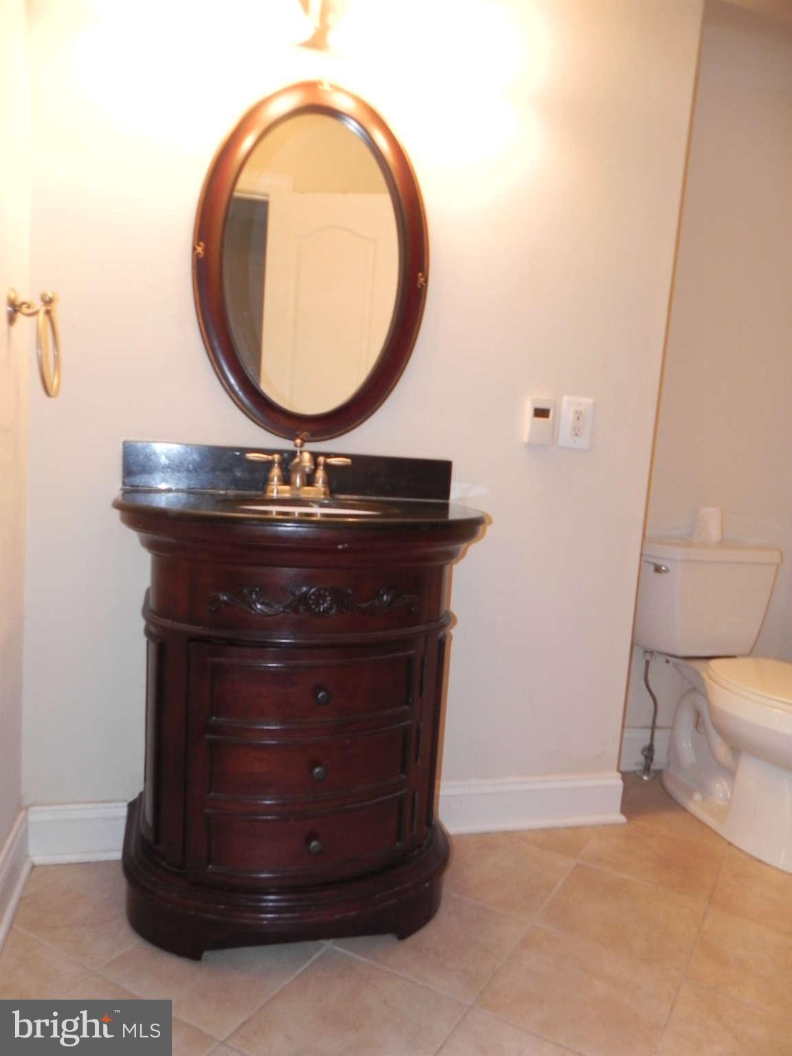 106 West Cross Street Baltimore, MD 21230 - Photo 24 of 29 a room with a sink and a mirror
