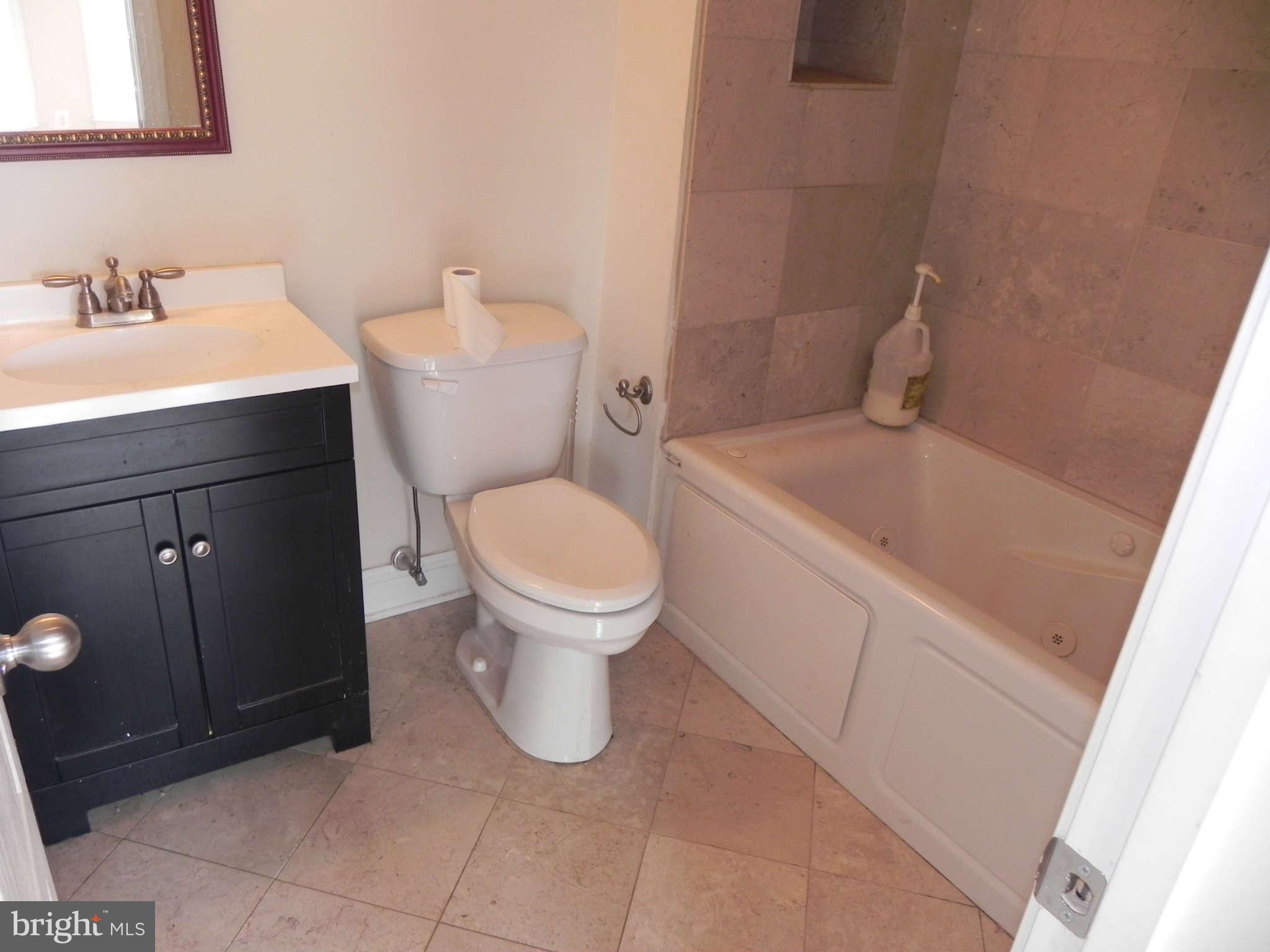 106 West Cross Street Baltimore, MD 21230 - Photo 25 of 29 a white toilet sitting next to a bathroom sink