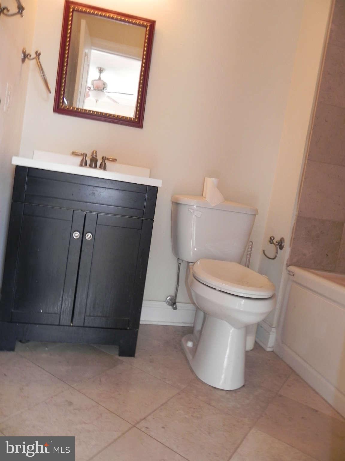 106 West Cross Street Baltimore, MD 21230 - Photo 27 of 29 a white toilet sitting next to a bathroom sink