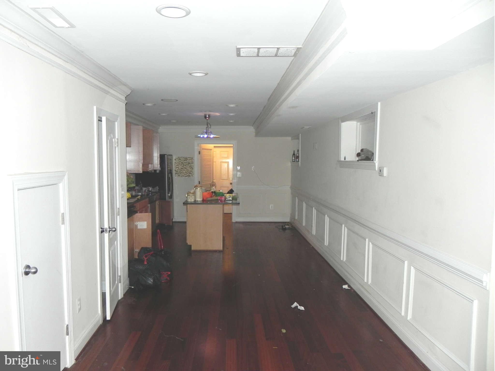 106 West Cross Street Baltimore, MD 21230 - Photo 6 of 29 a view of a hallway with dining room and wooden floor