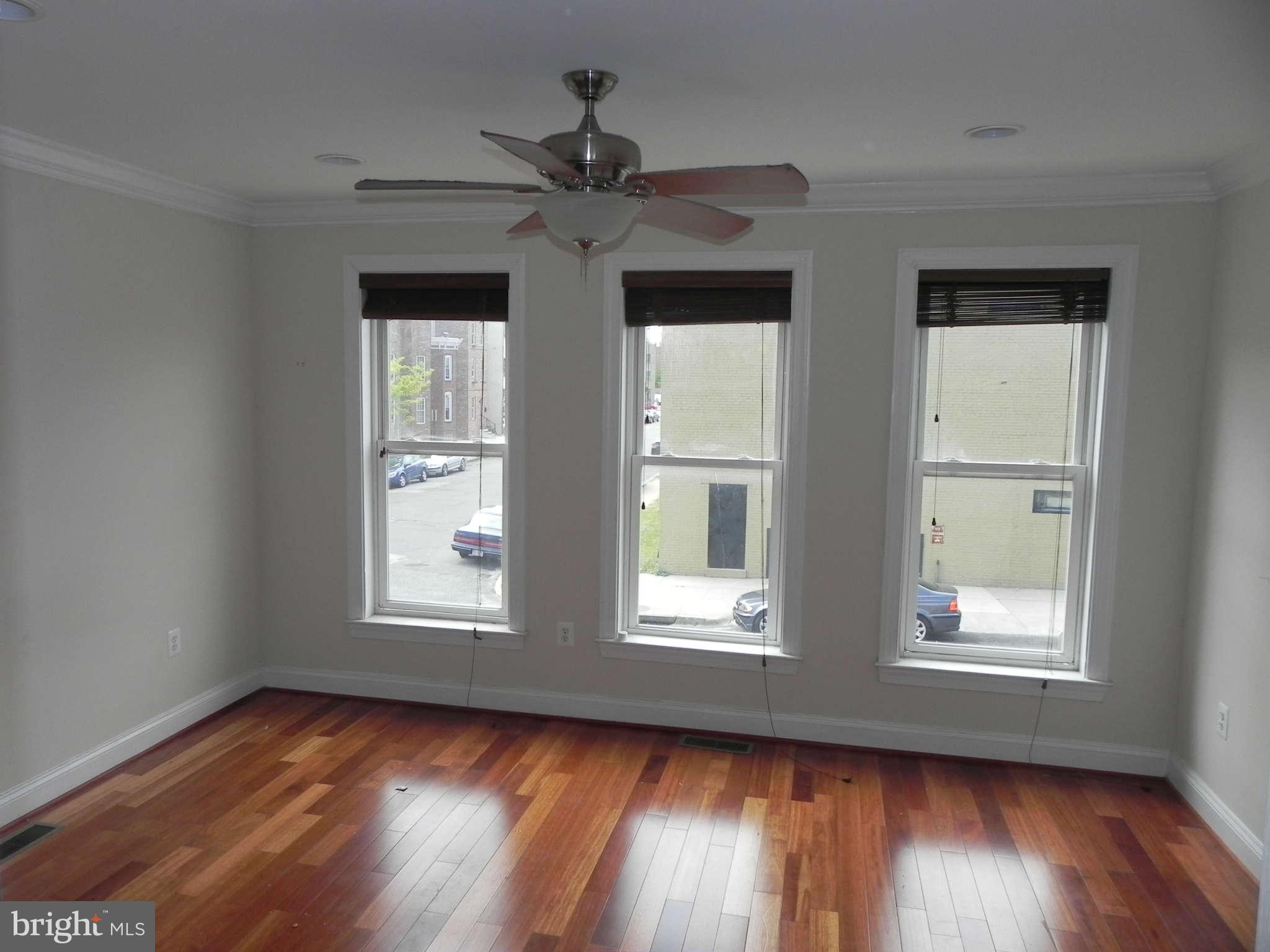 106 West Cross Street Baltimore, MD 21230 - Photo 10 of 29 a view of an empty room with wooden floor and a window