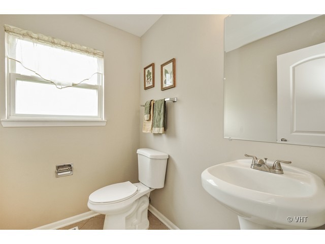 115 Moonlight Road Matteson, IL 60443 - Photo 10 of 10 a bathroom with a toilet sink and mirror