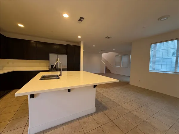 a kitchen with a sink a counter top space and cabinets