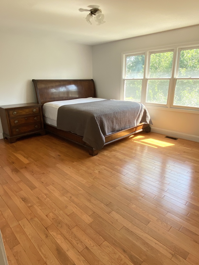 1900 Eagle Circle New Lenox, IL 60451 - Photo 12 of 16 a bedroom with a bed and wooden floor