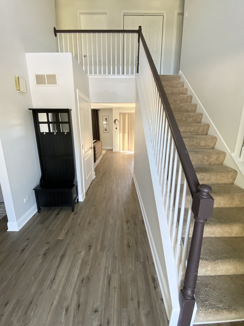 1900 Eagle Circle New Lenox, IL 60451 - Photo 2 of 16 a view of a hallway with wooden floor and stairs
