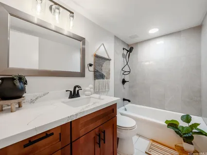a bathroom with a double vanity sink toilet and shower