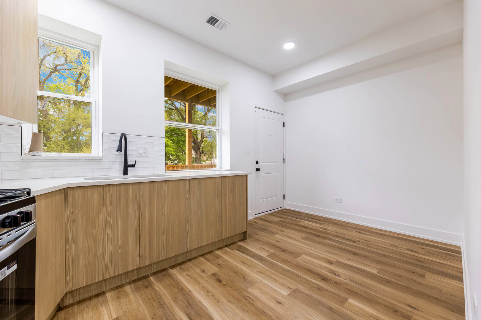 243 West 74th Street, Unit 2 Chicago, IL 60621 - Photo 4 of 12 a view of wooden floor and cabinet in a room