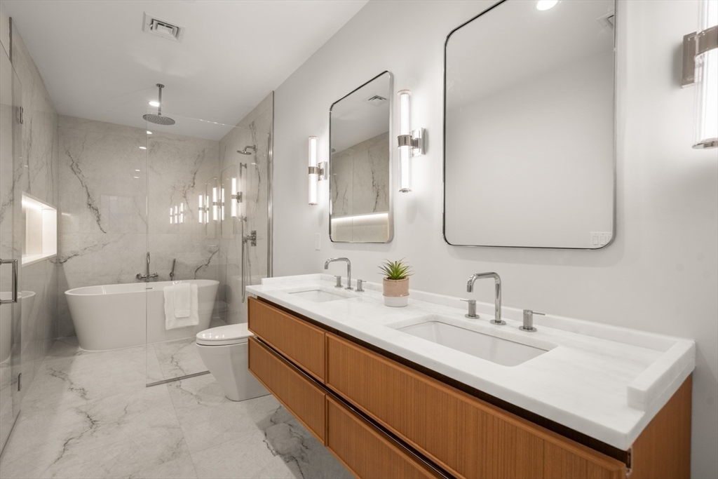 144 Worcester Street, Unit 2 Boston, MA 02118 - Photo 19 of 33 a bathroom with a double vanity sink mirror and bathtub