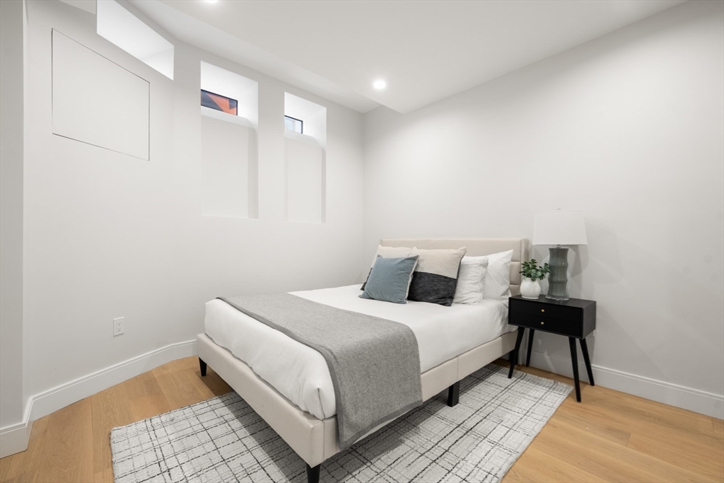 144 Worcester Street, Unit 2 Boston, MA 02118 - Photo 22 of 33 a bed room with a bed and a lamp