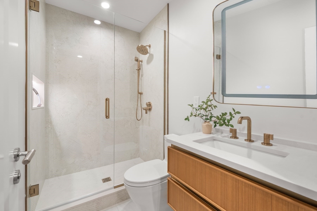 144 Worcester Street, Unit 2 Boston, MA 02118 - Photo 24 of 33 a bathroom with a granite countertop sink a toilet and shower
