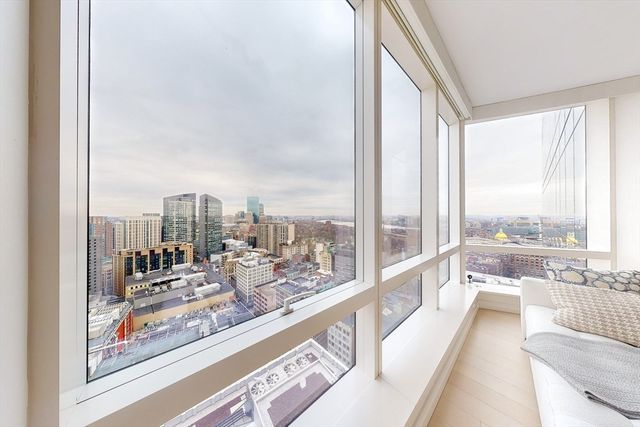 a view of a living room and floor to ceiling window or couch