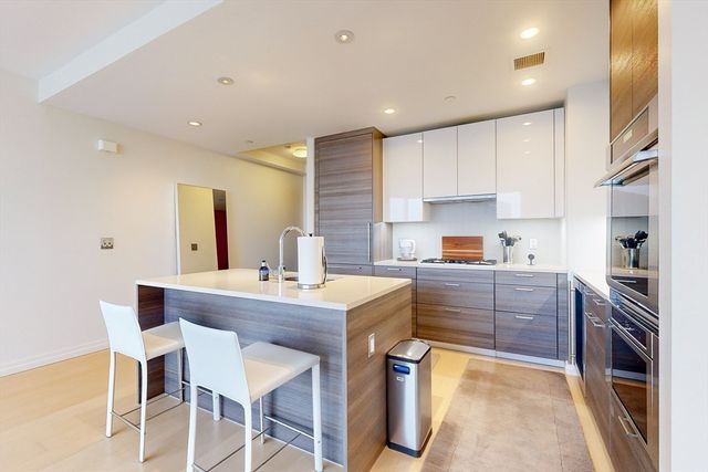 a living room with furniture a flat screen tv and a floor to ceiling window