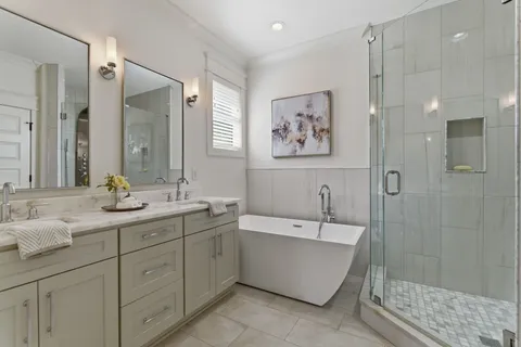 a bathroom with a double vanity sink mirror double and bathtub