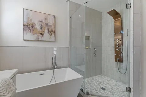 a bathroom with a tub and a shower