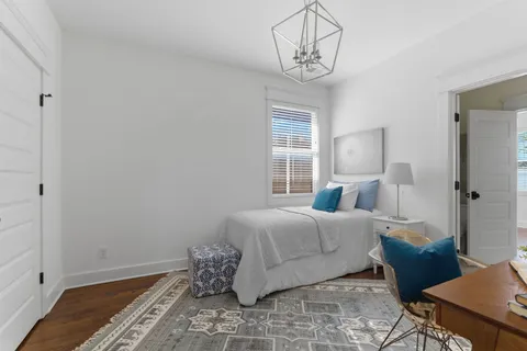 a bedroom with a bed and window