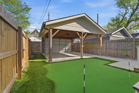 a view of a small house with wooden fence