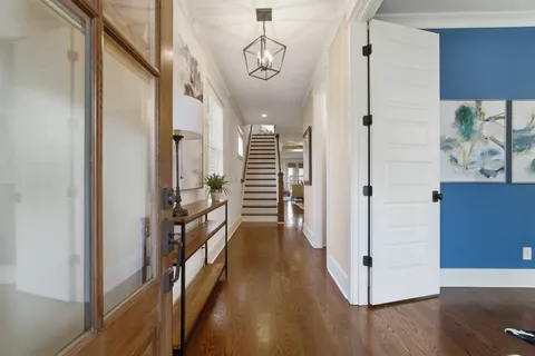 a view of a hallway view with wooden floor and staircase