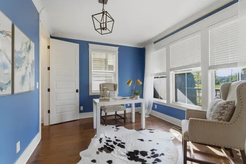 a workspace with furniture window and wooden floor