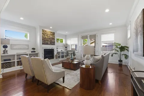 a living room with fireplace furniture and a wooden floor