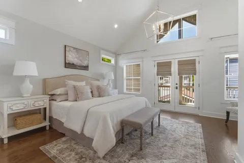 a bedroom with a bed and a view of kitchen