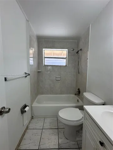 a bathroom with a toilet a sink and bathtub