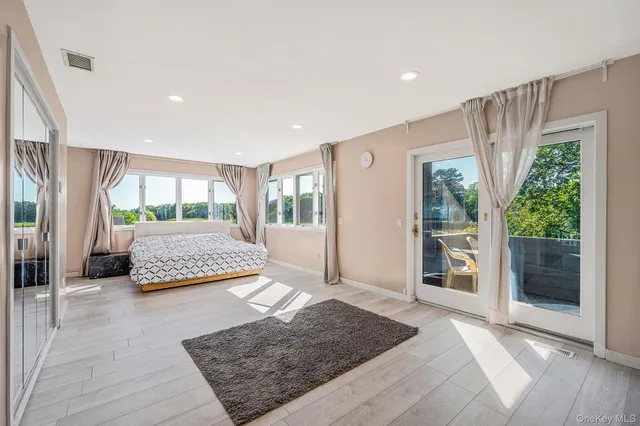 a bathroom with a tub sink shower and mirror