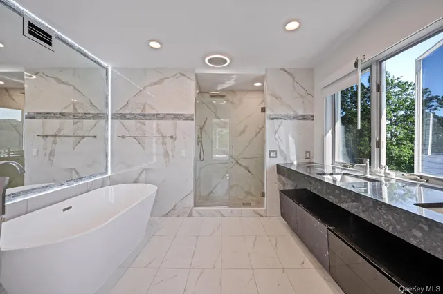 a bathroom with a white tub shower and toilet
