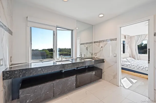 a living room with furniture a floor to ceiling window and floor to ceiling window