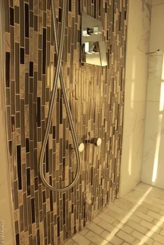 a living room with furniture and floor to ceiling windows