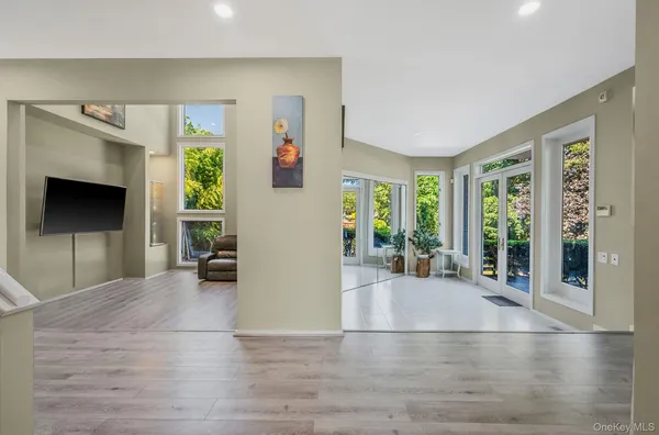 a view of a livingroom with wooden floor and a flat screen tv